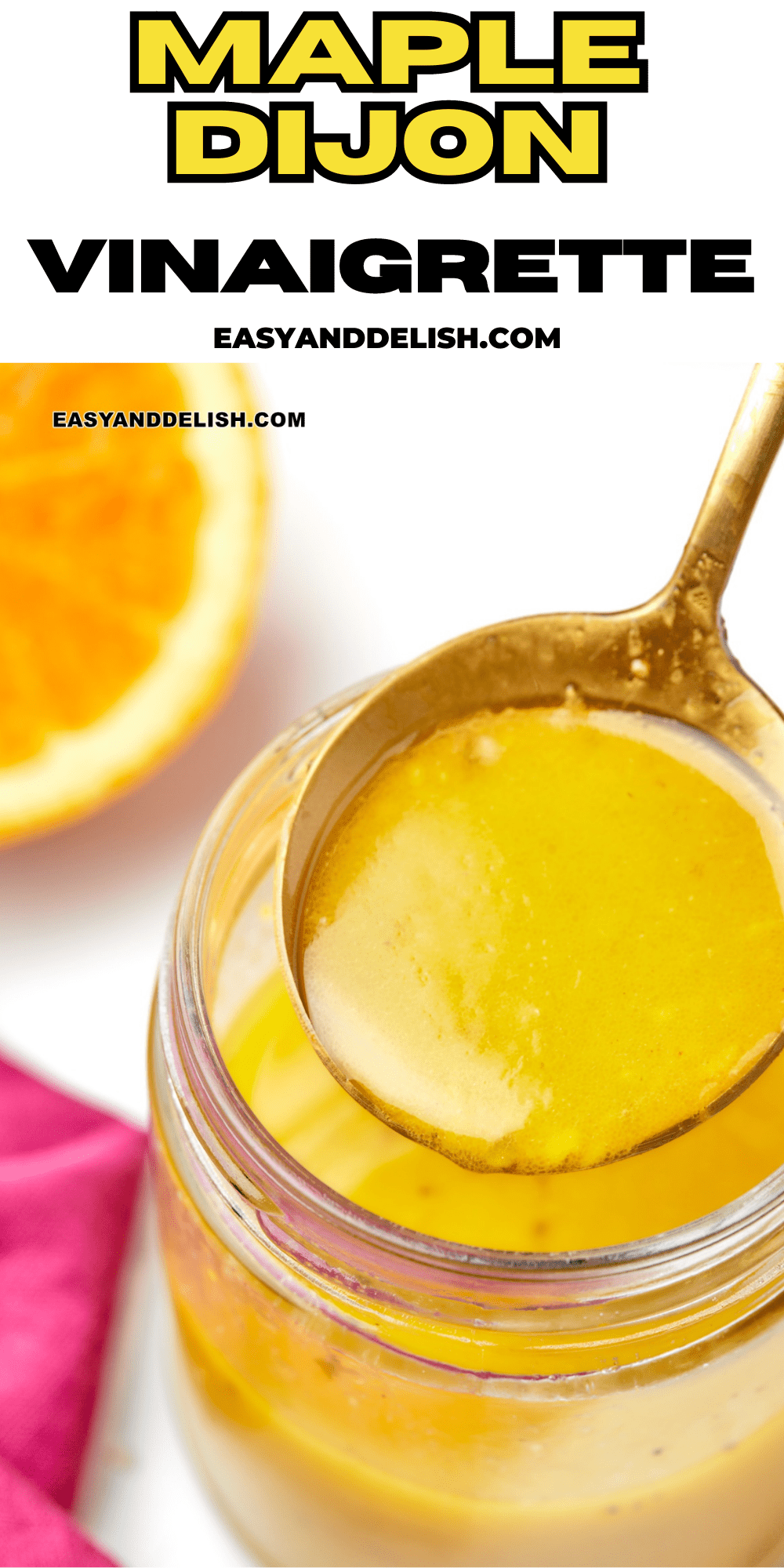 close up of a spoon with maple dijon vinaigrette over a jar.