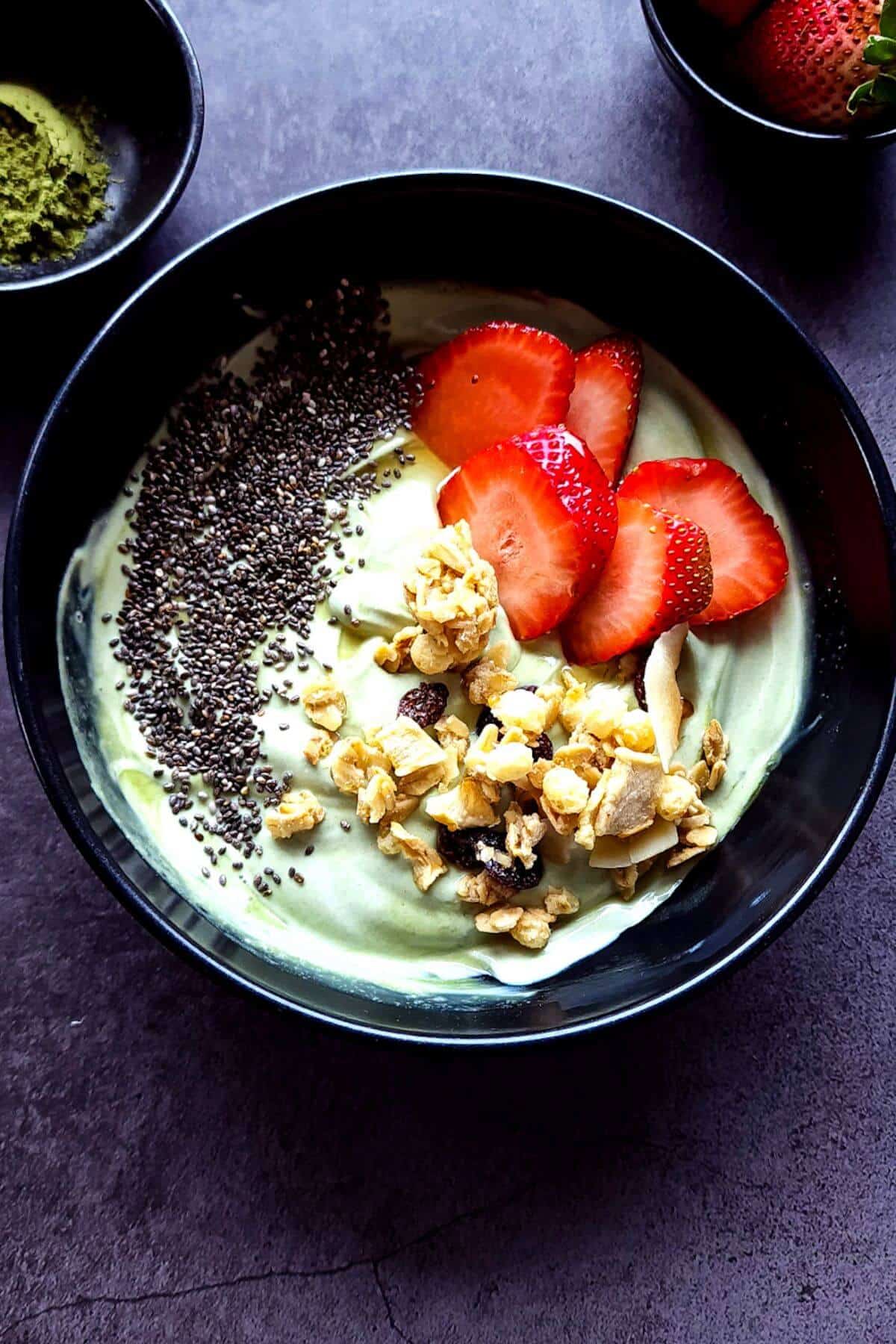 matcha yogurt ina bowl with fruits.