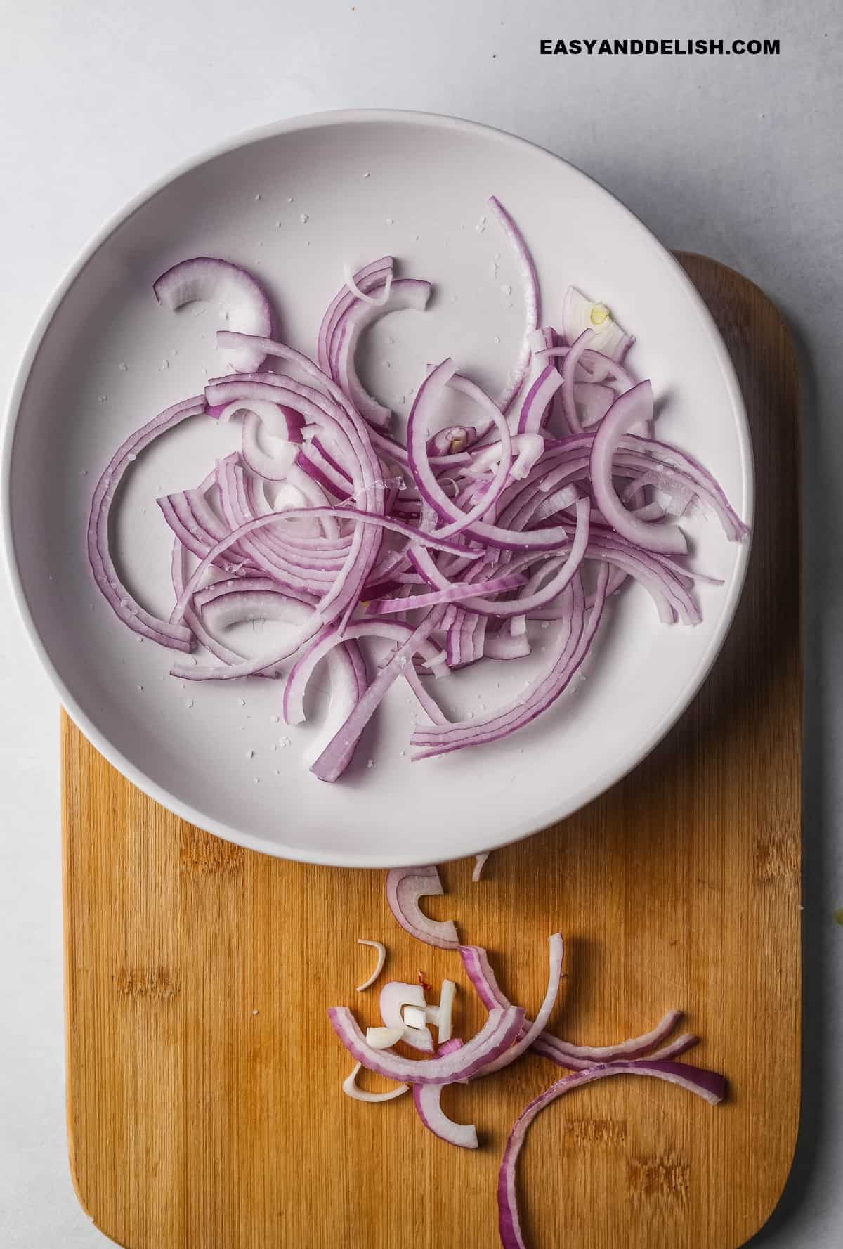 a bowl with macerated onions and salt.