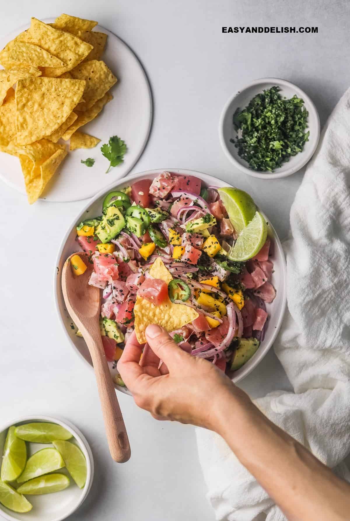 a bowl of tuna ceviche served with tortilla chips.