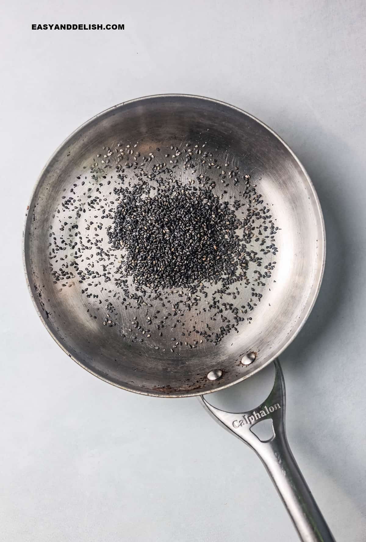 a skillet with toasted black sesame seeds.