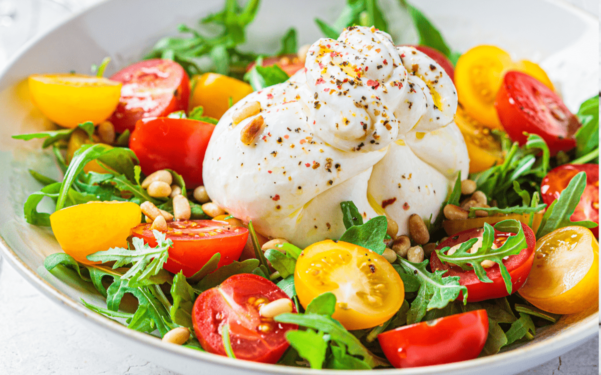 Tomato and burrata salad in a bowl.