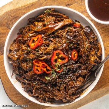 close up image of slow-cooked pulled brisket in a bowl.