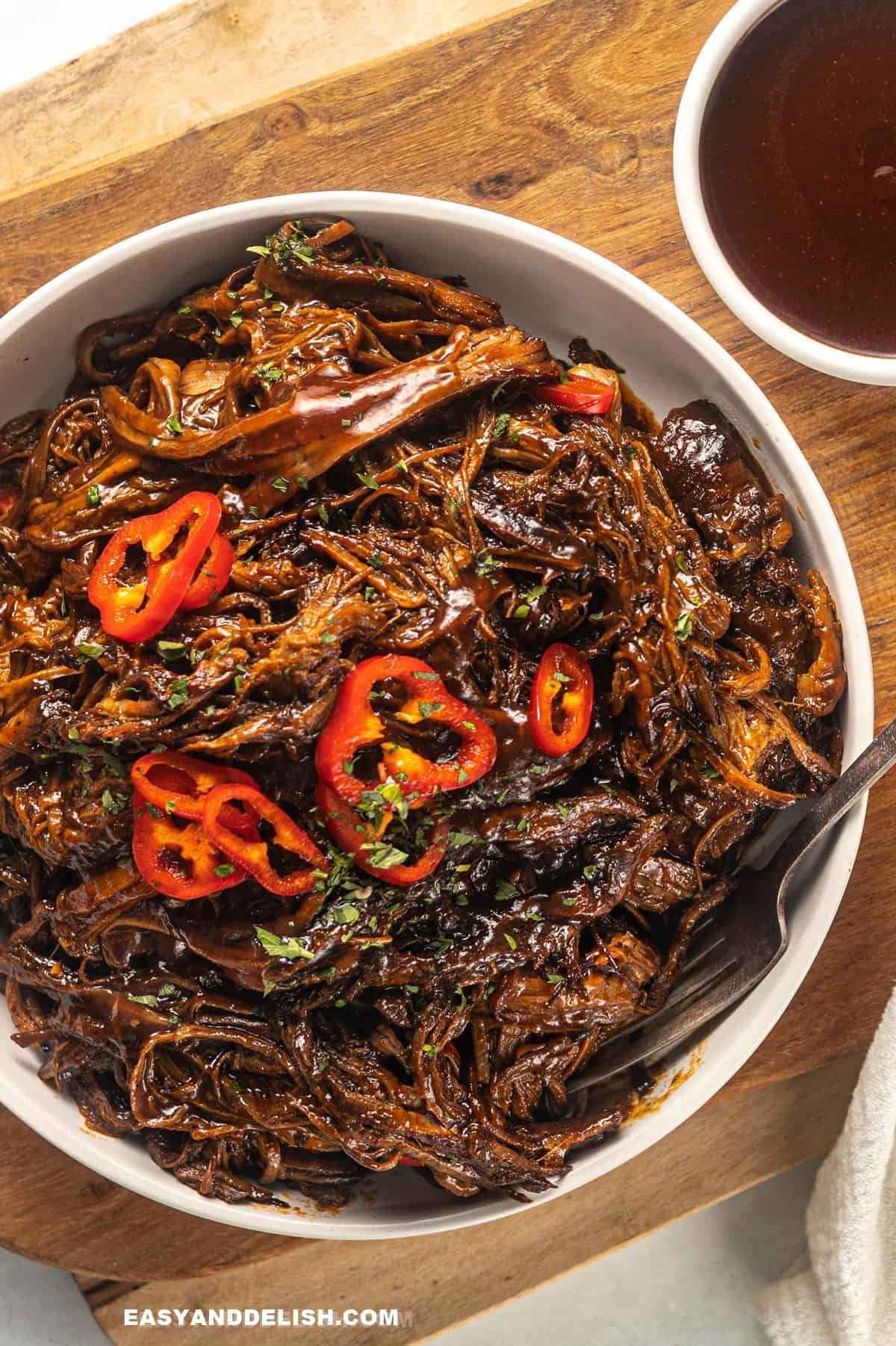 a bowl of pulled brisket with bbq sauce.