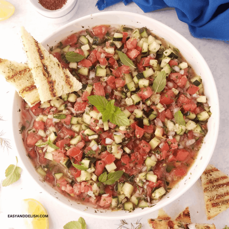 A bowl of shirazi salad with a mini toast on the side.