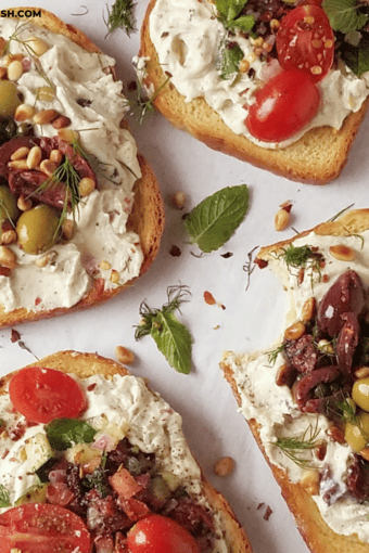 close up of several ricotta toasts with two different savory toppings.
