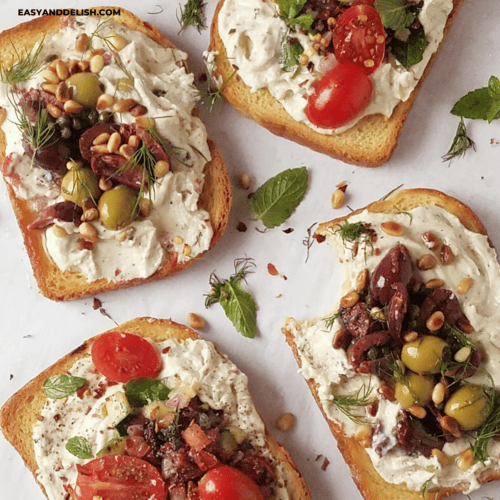 close up of several ricotta toasts with two different savory toppings.