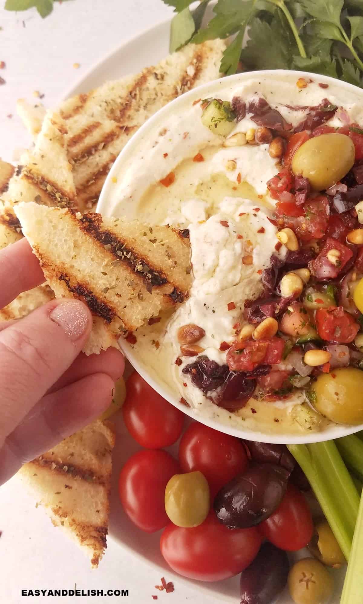 dipping toast in whipped rcotta dip.
