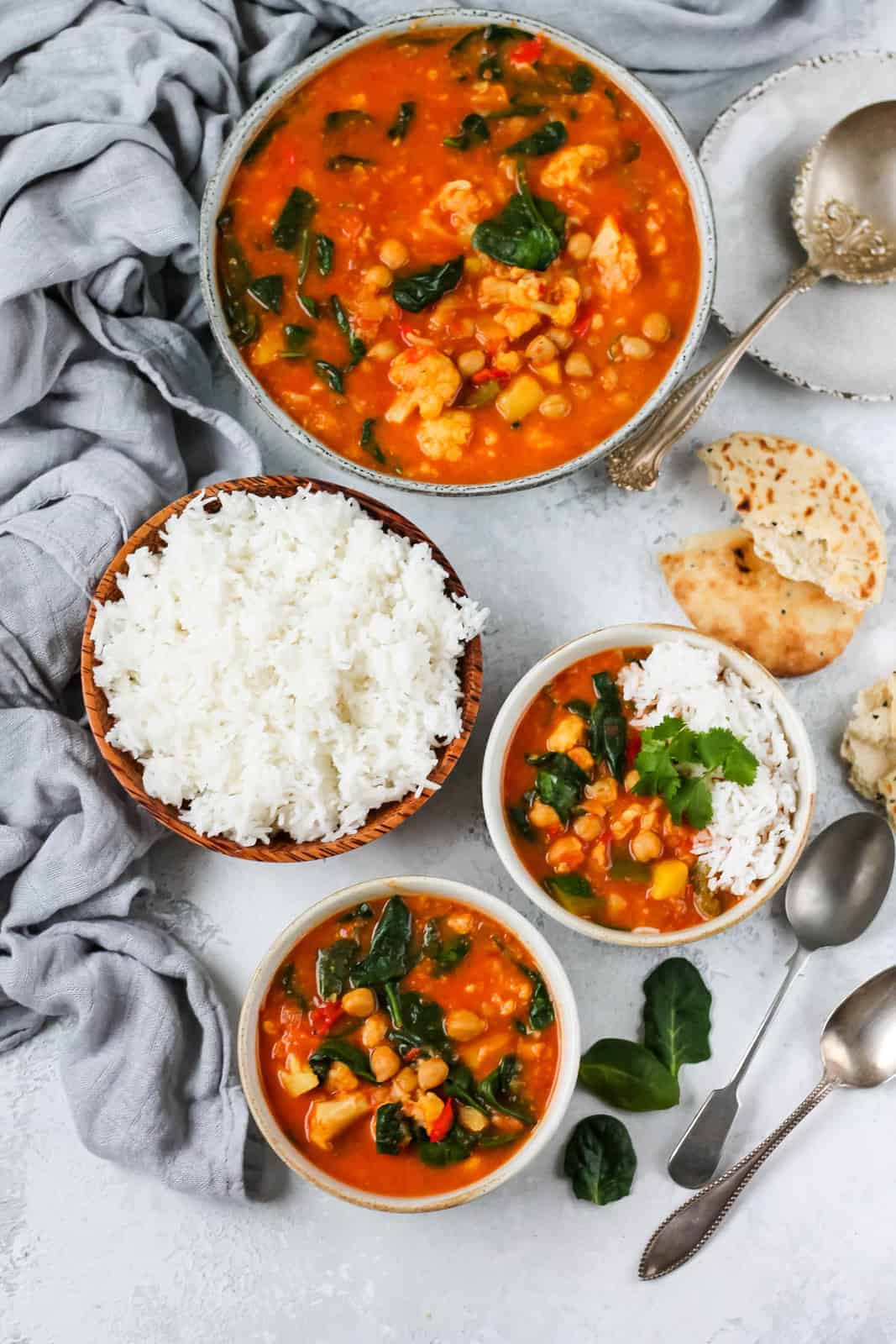 slow cooker chickpea curry in bowls with rice on the side as one of our easy healthy crockpot meals. 