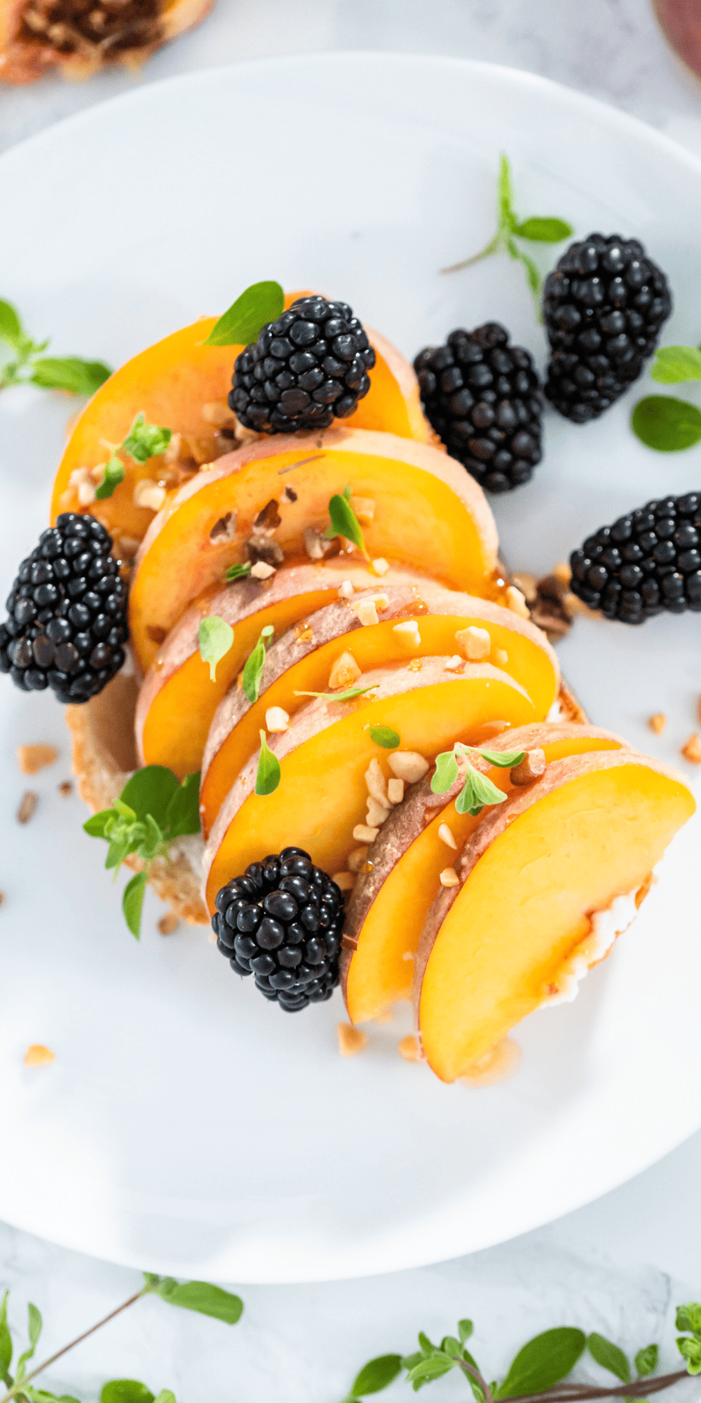 A toast with whipped ricotta with honey, peaches, and nuts.