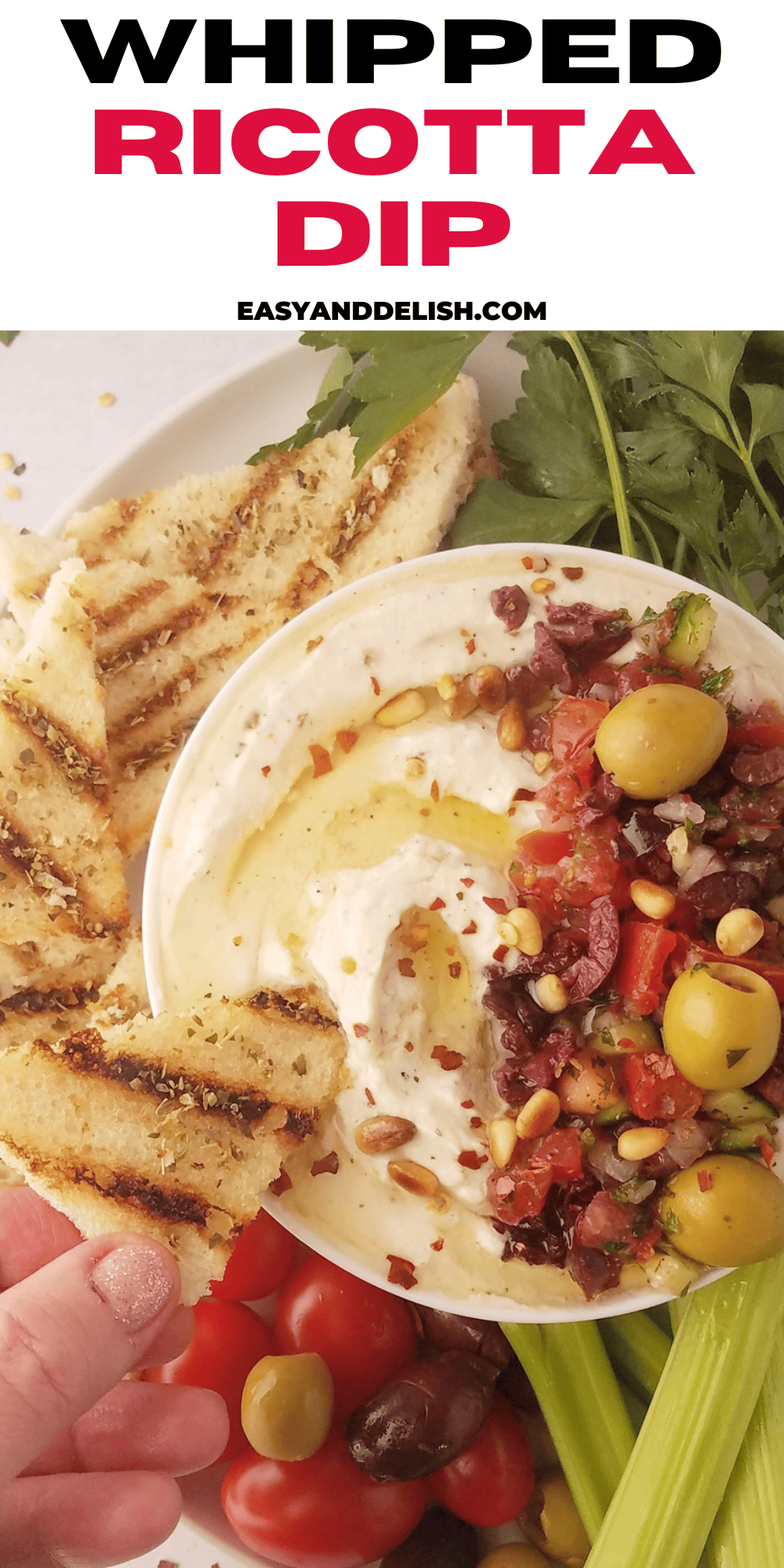 close up of whipped ricotta dip in abowl with a piece of toasted dipped in it.