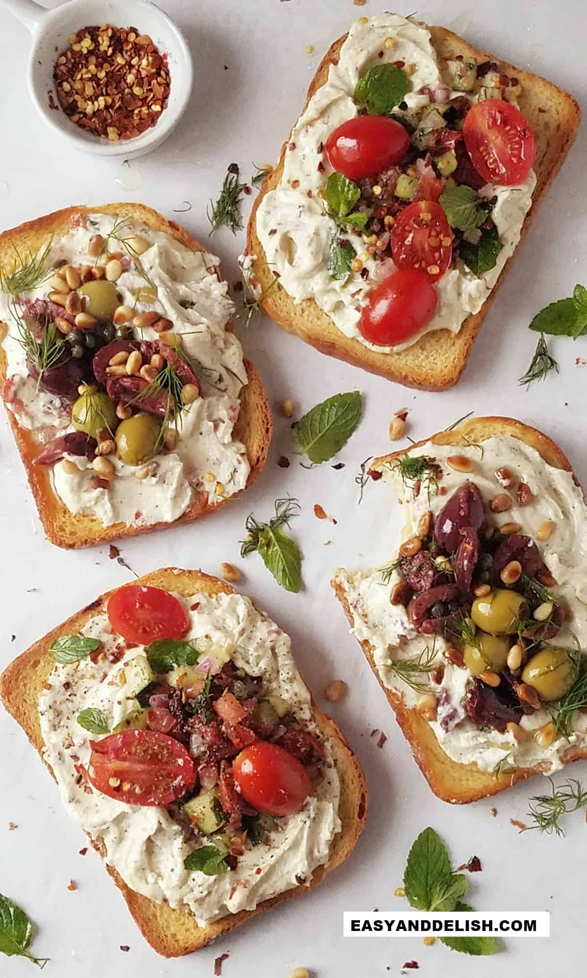 four whipped ricotta toasts with savory toppings.