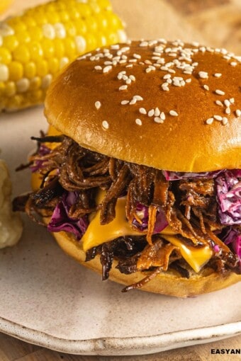 close up of a bbq brisket sandwich on a plate.