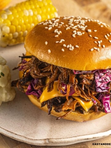 close up of a bbq brisket sandwich on a plate.