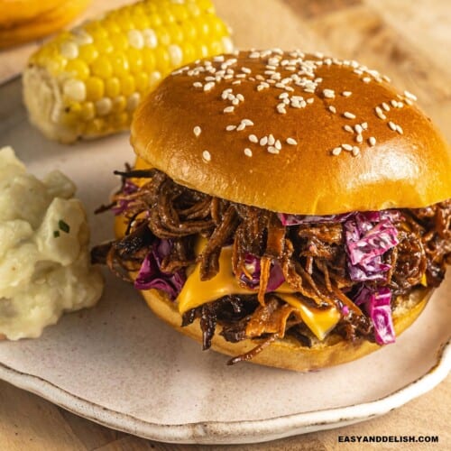 close up of a bbq brisket sandwich on a plate.