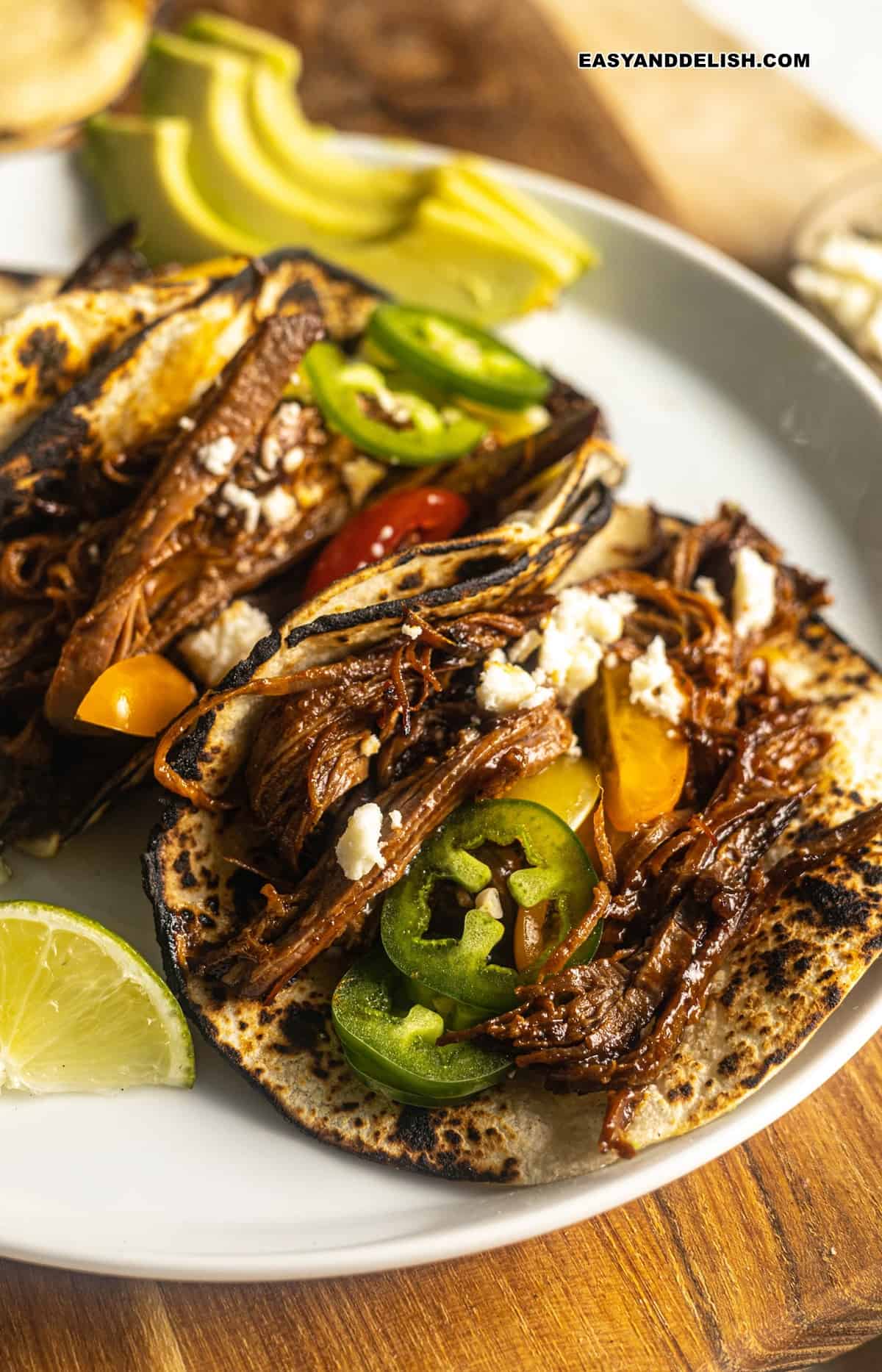 several bbq beef brisket tacos in a plate.