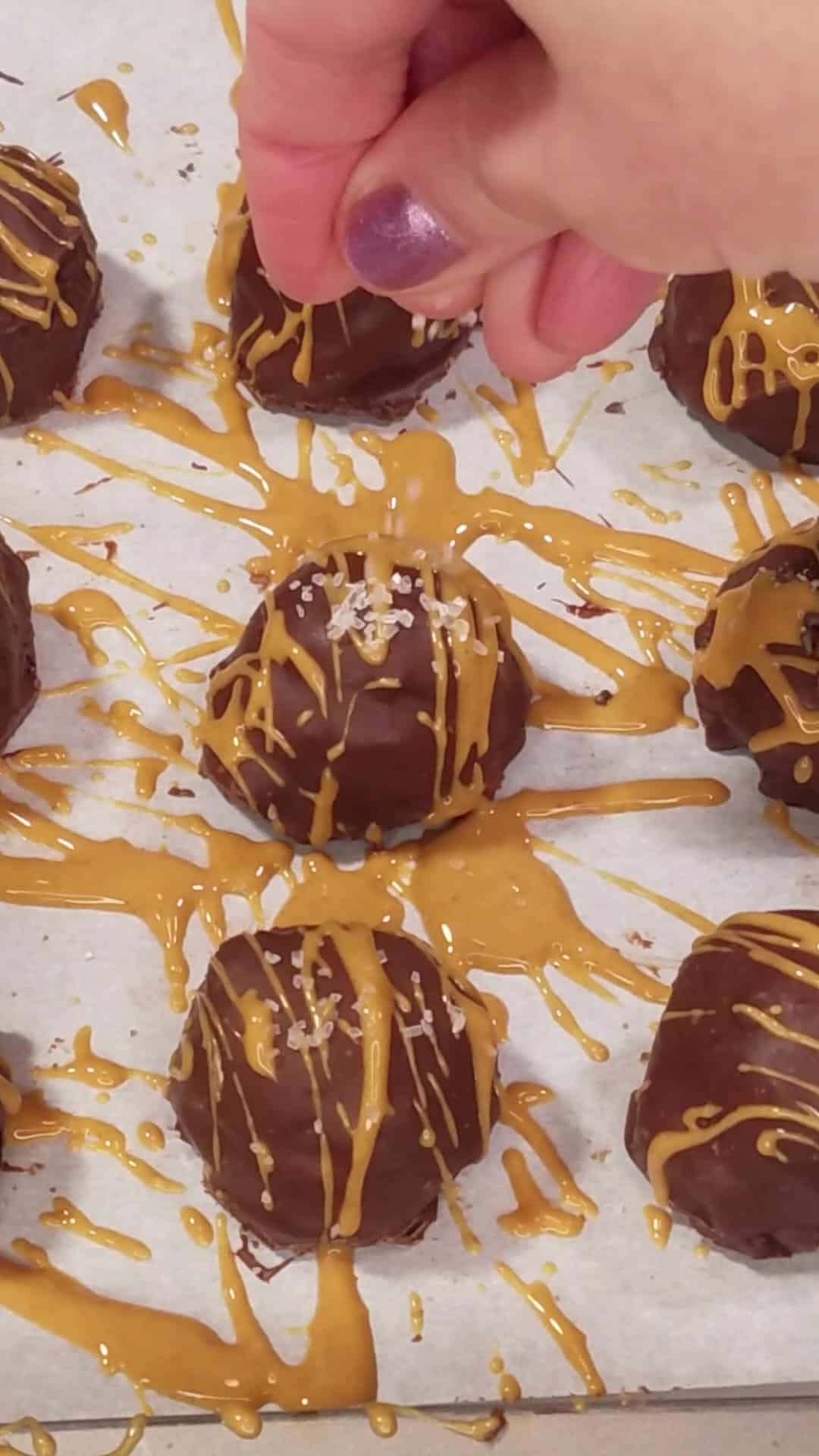 Drizzling protein balls with melted peanut butter.