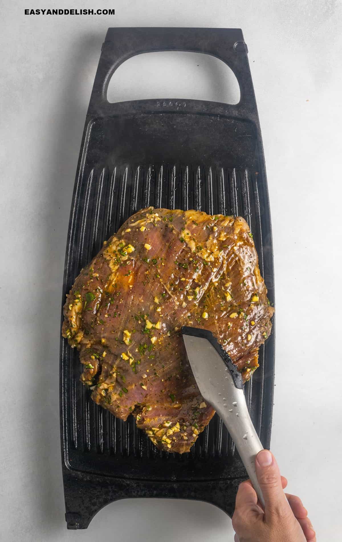 marinated steak grilled on a griddle.