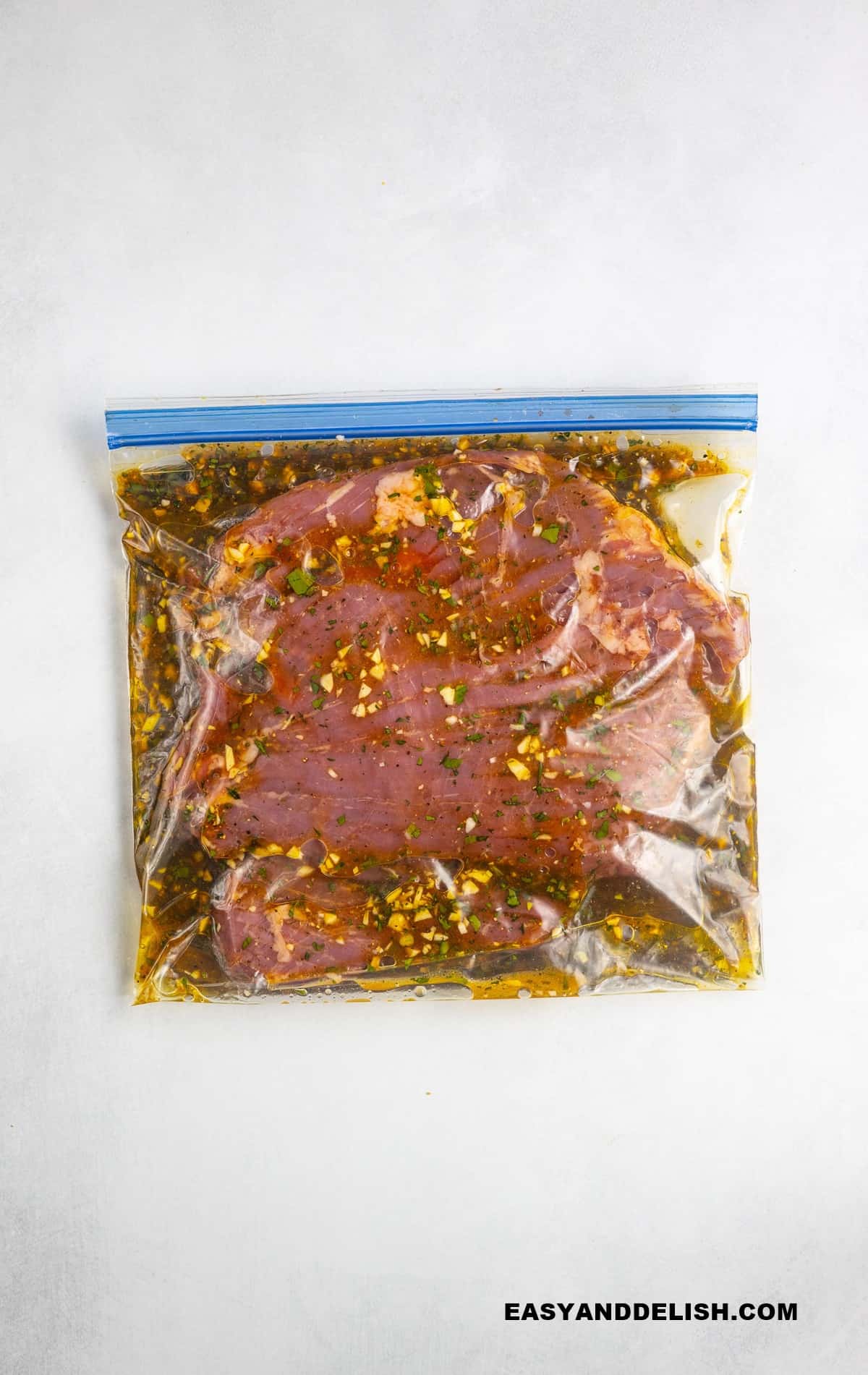 steak marinating in a ziploc bag.