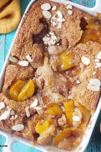 close up of easy lazy man's peach cobbler with canned peaches and toasted almonds on top.