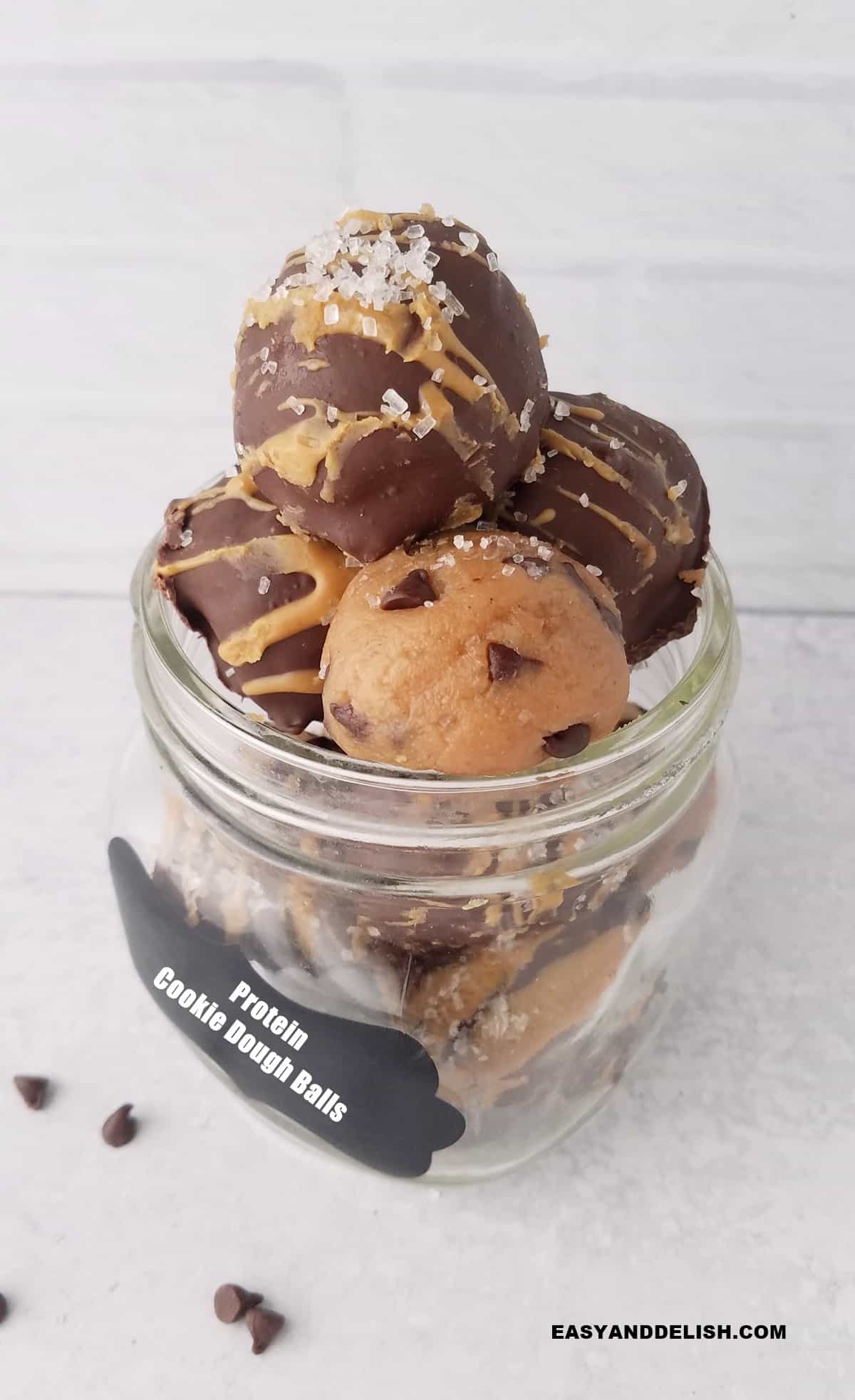 chocolate chip protein cookie dough balls in a mason jar.