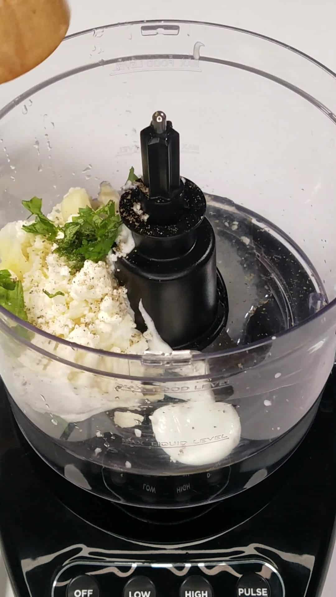 Yogurt sauce ingredients in a food processor.