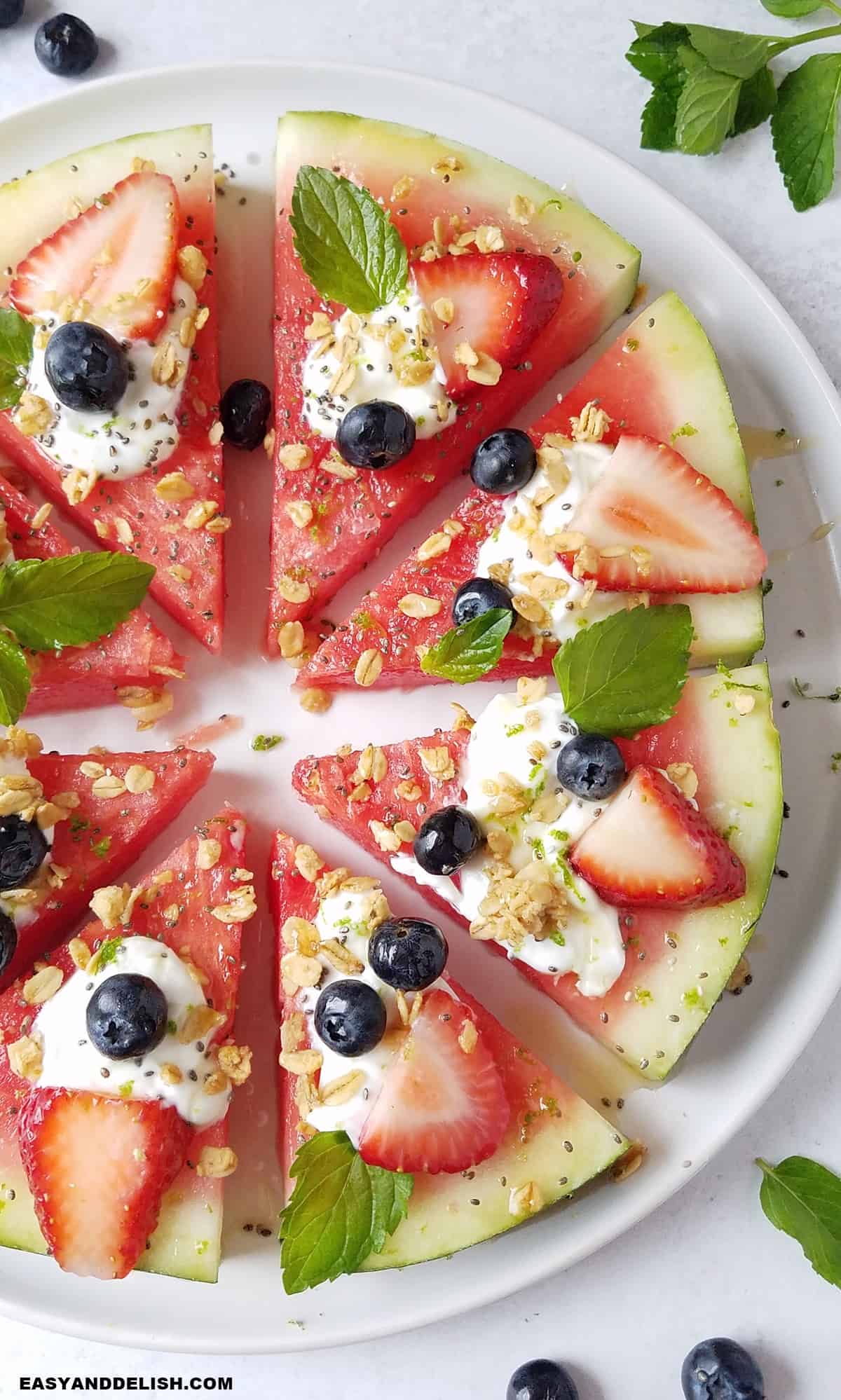 half of watermelon fruit pizza in a platter.