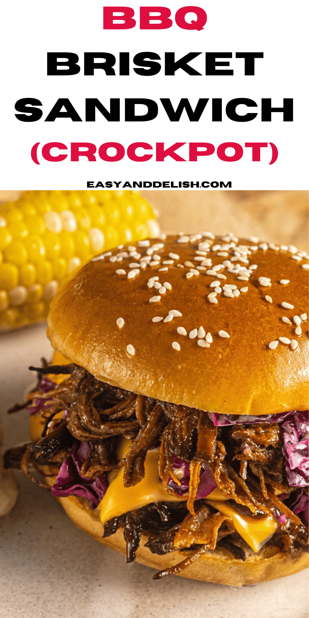 crockpot bbq brisket sandwich on a plate with a corn on the cob behind it.