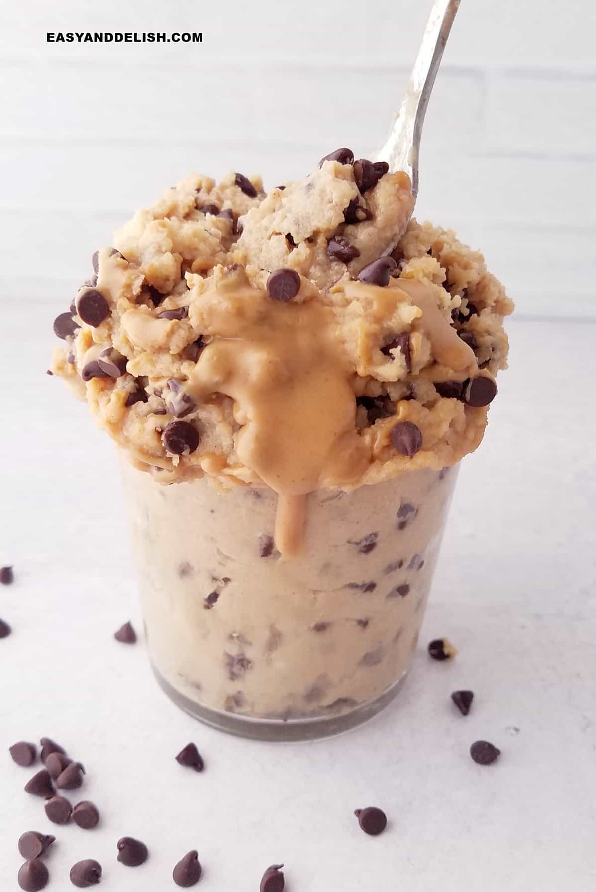 a healthy snack or dessert in a glass with a spoon on top.