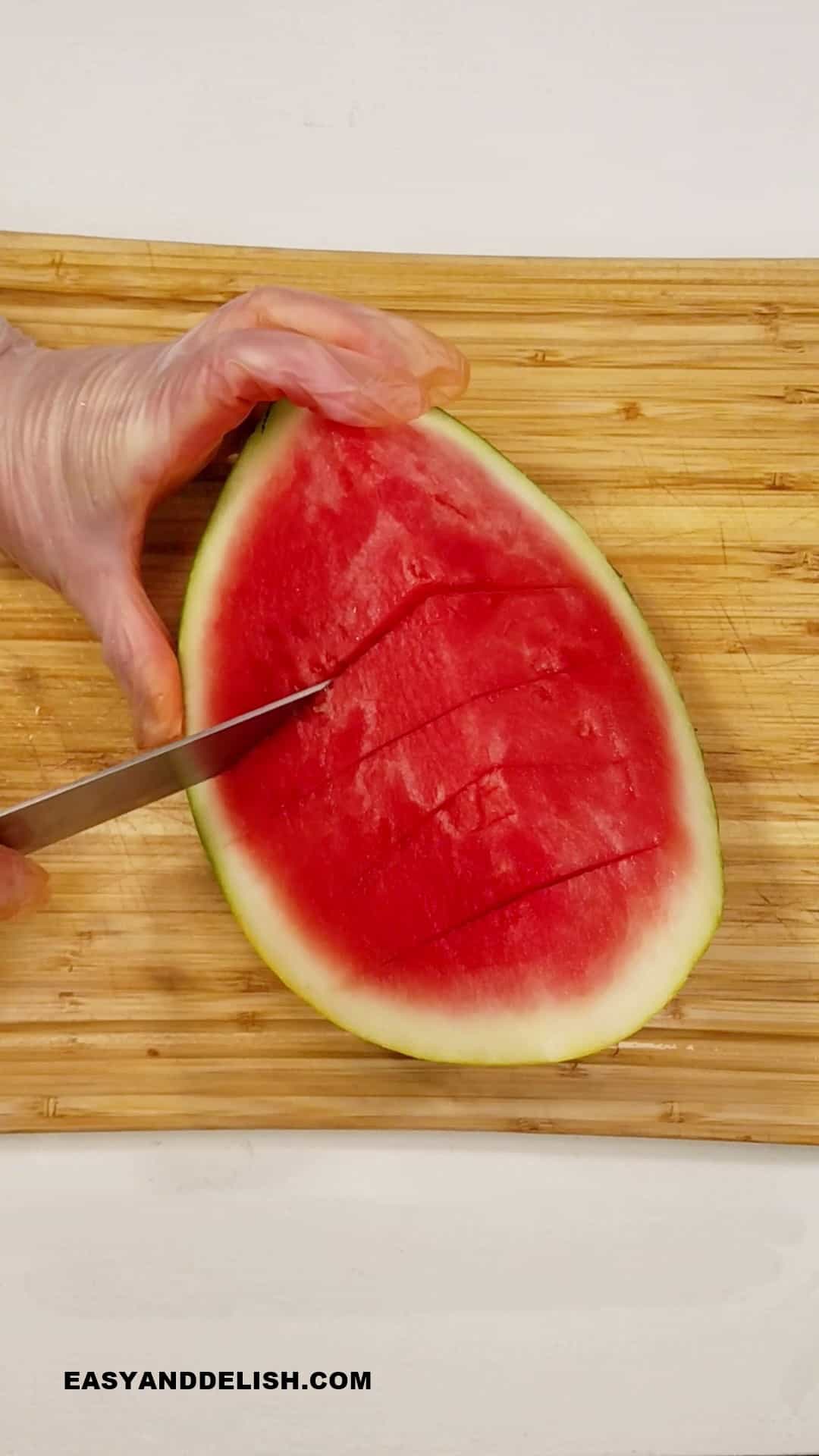 cutting melon quarters into cubes.