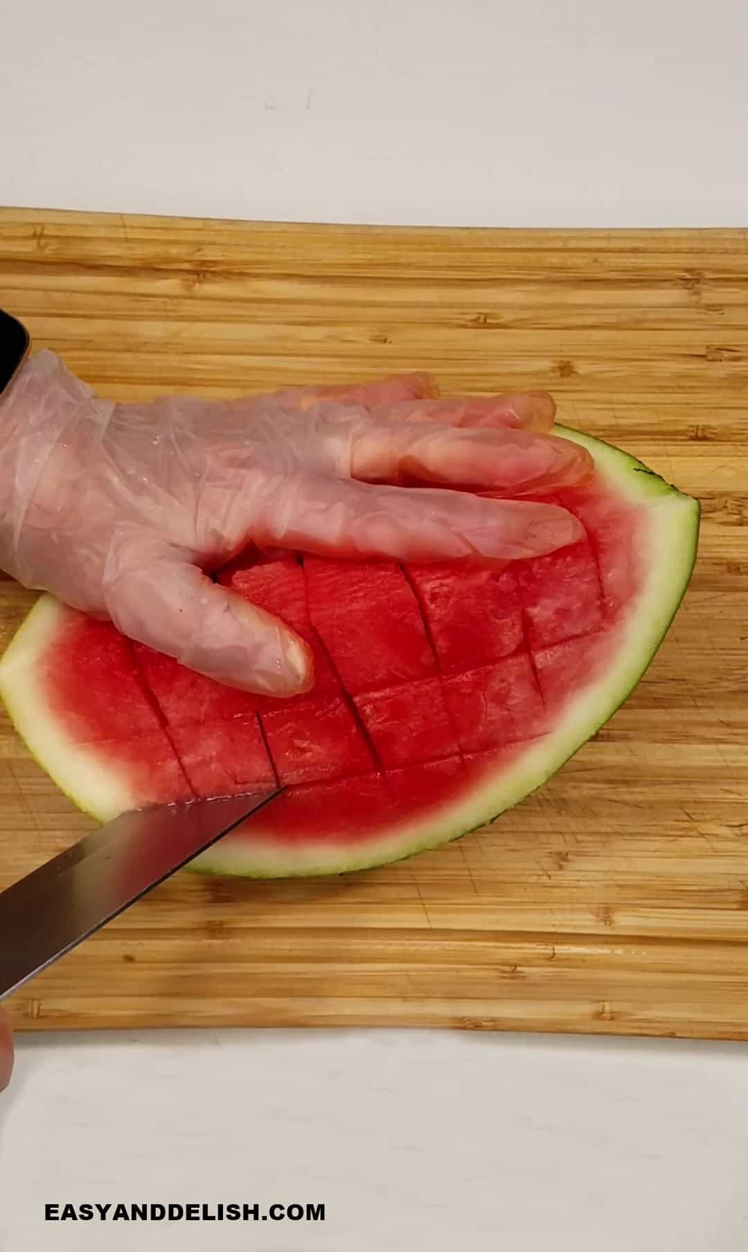 slicing melon quarters crosswise.