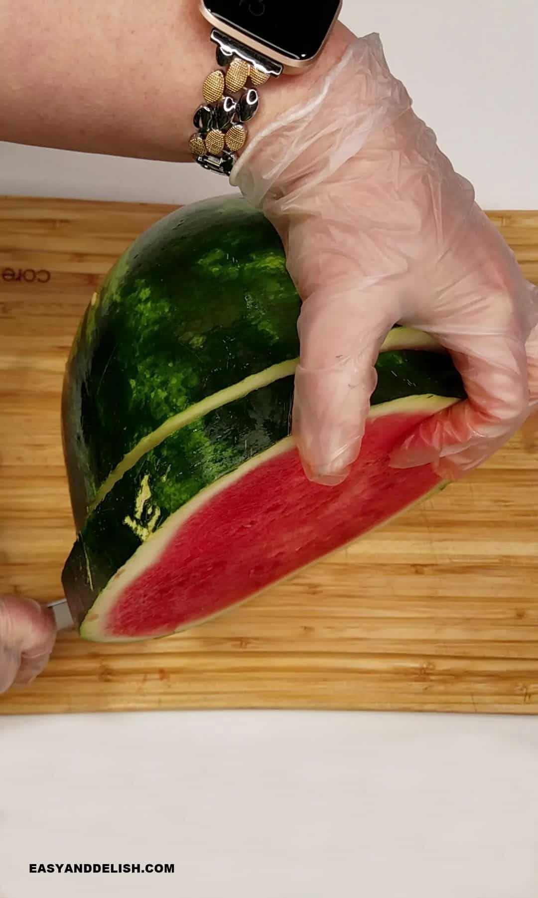 slicing a watermelon into rounds.