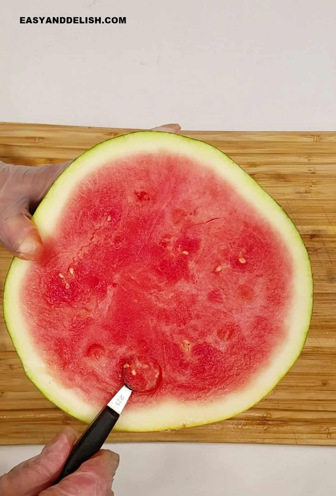 a melon baller scooping watermelon balls.