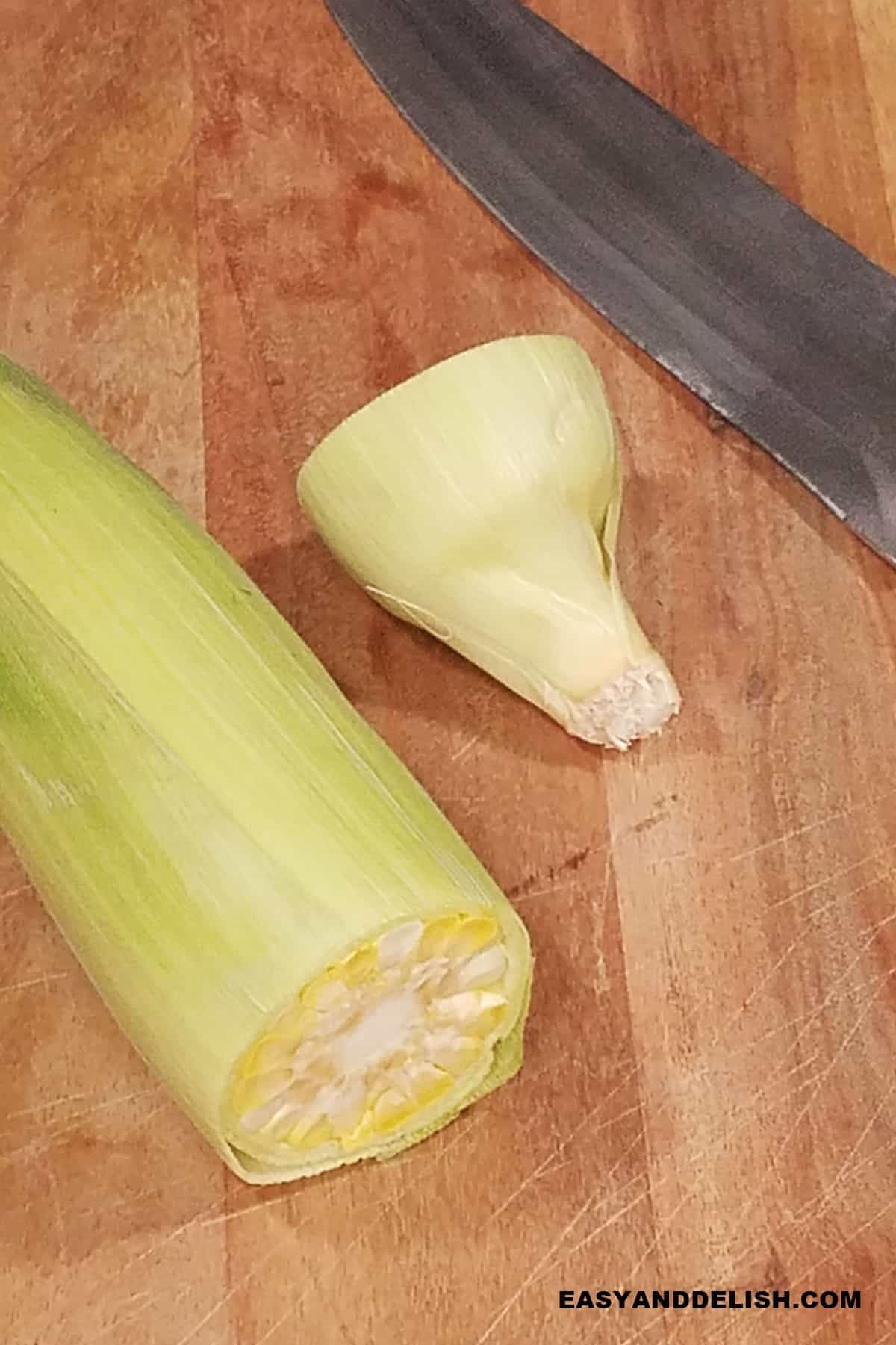 cut off end of an ear of fresh corn before shucking.