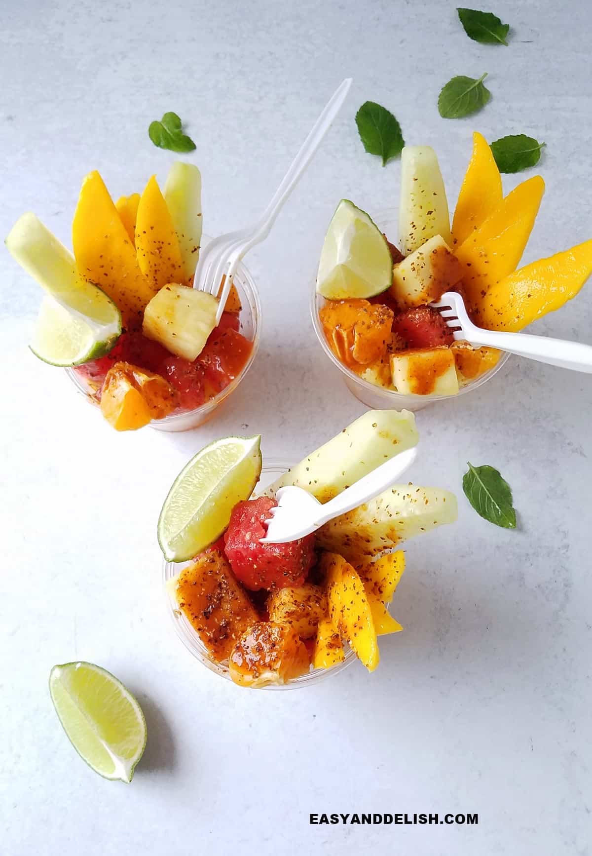 Mexican fruit cups for party on a table.