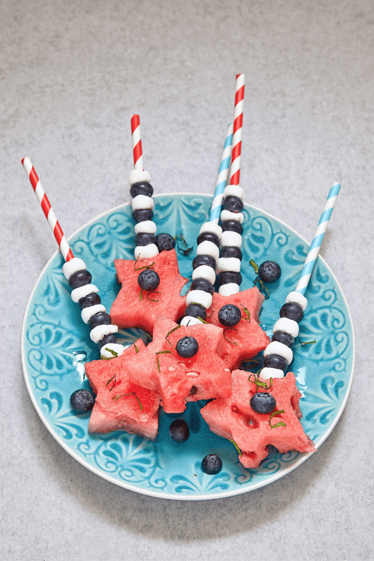 melon and berry kabobs in a platter. 