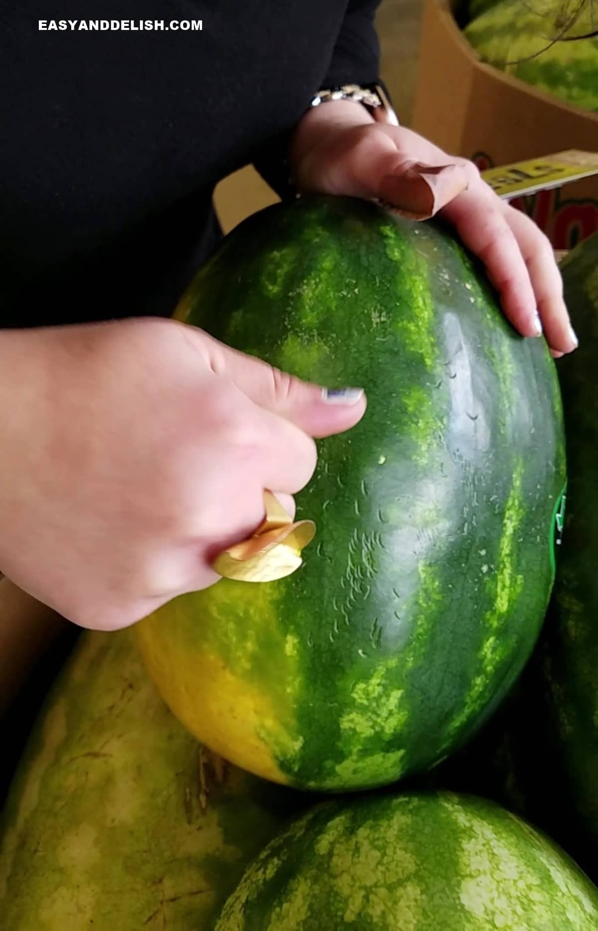 a knuckle thumping on melon exterior.