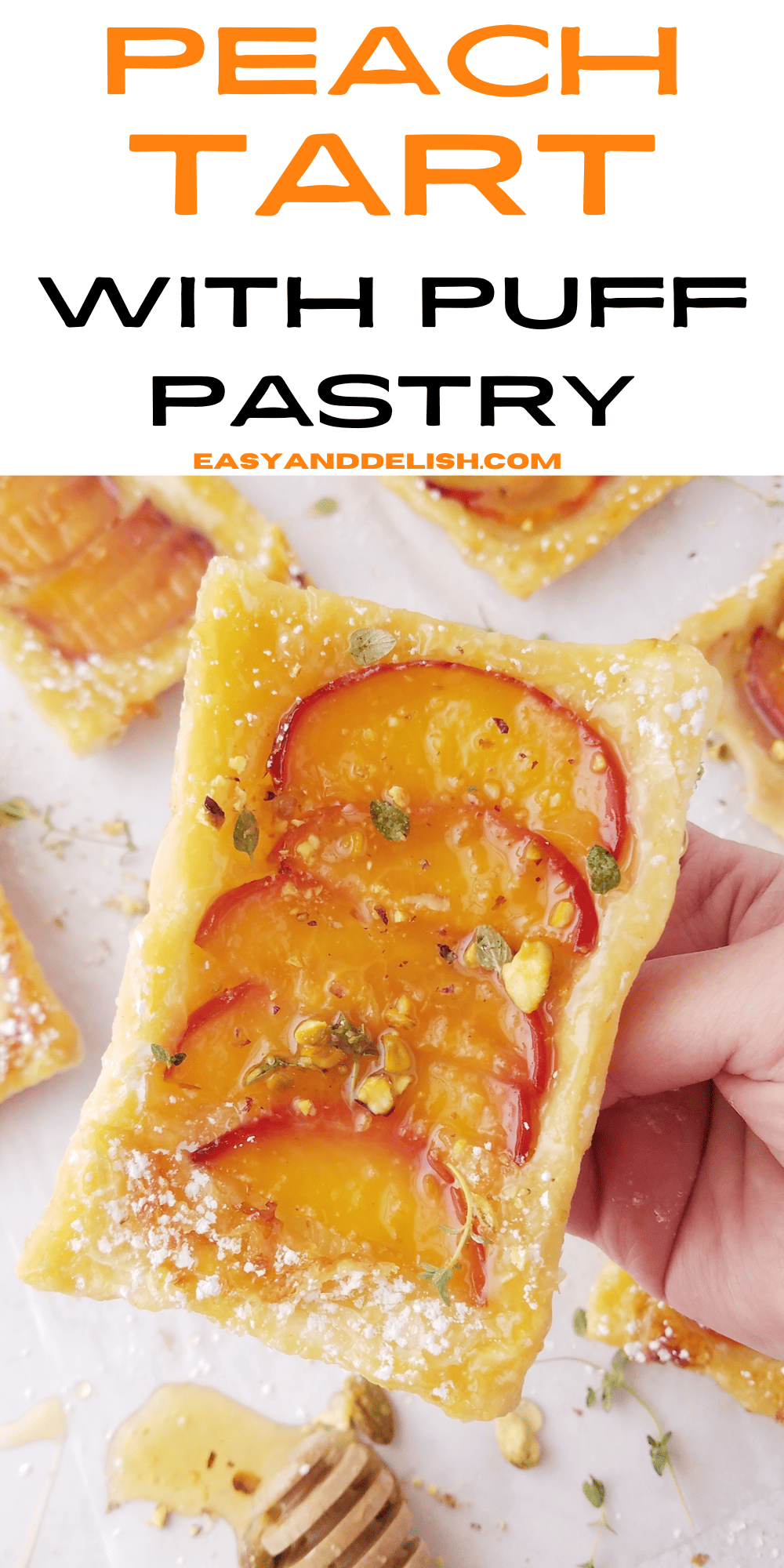 pin showing close up of a peach tart with puff pastry base being holded up.