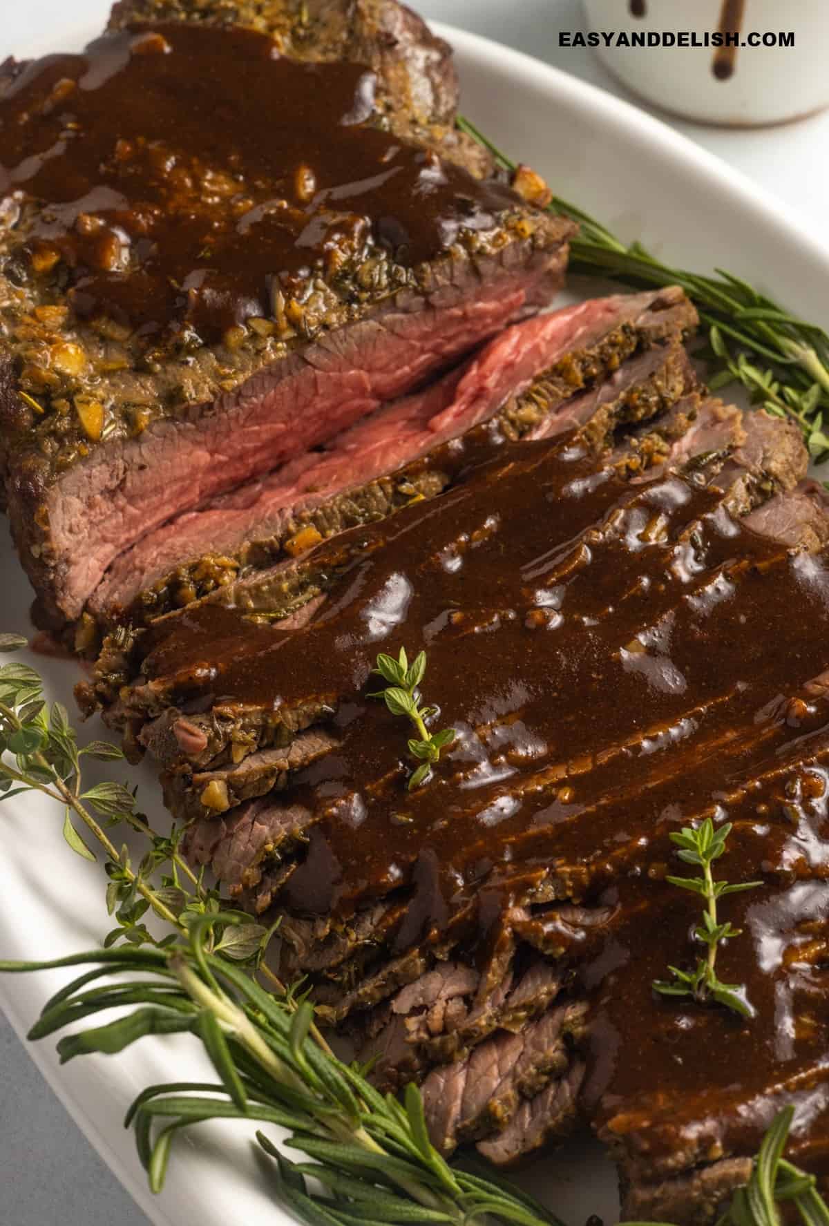 close up image of sliced cut of meat with gravy.