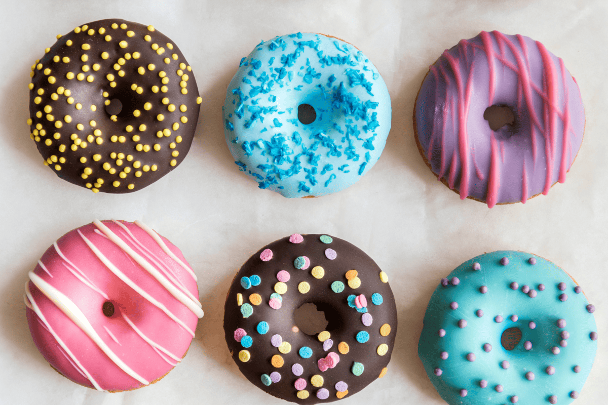 several donuts on a table, which are inflammatory foods.