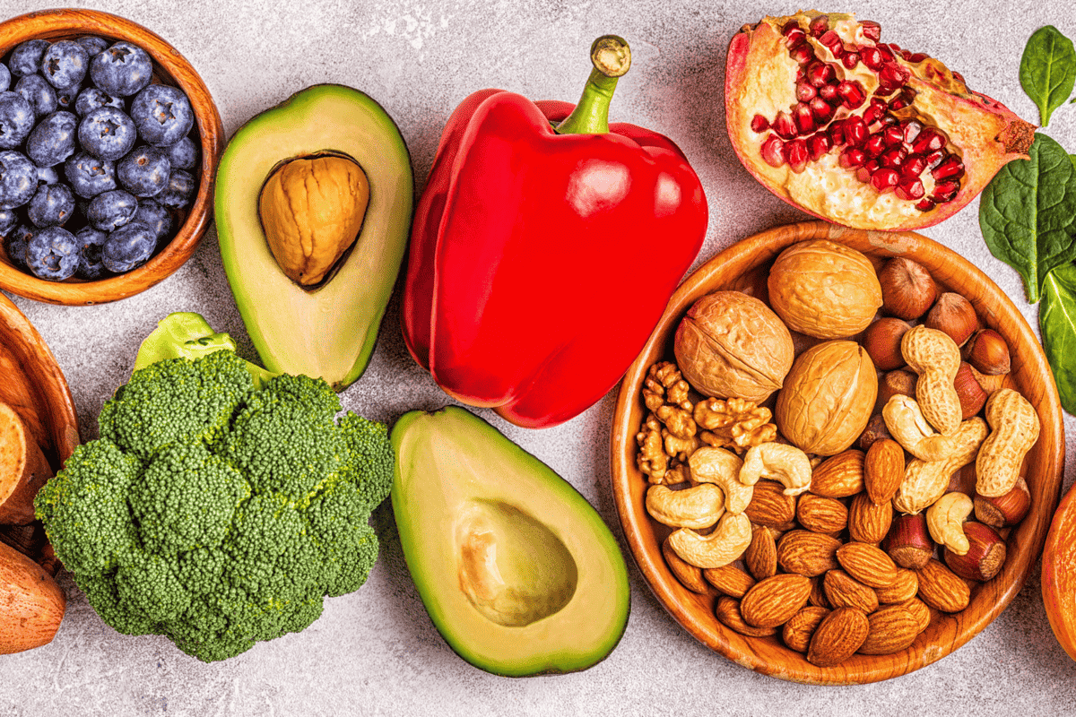fruits, veggies, and nuts on a table.