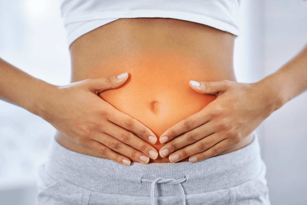 woman touching n inflammed belly.