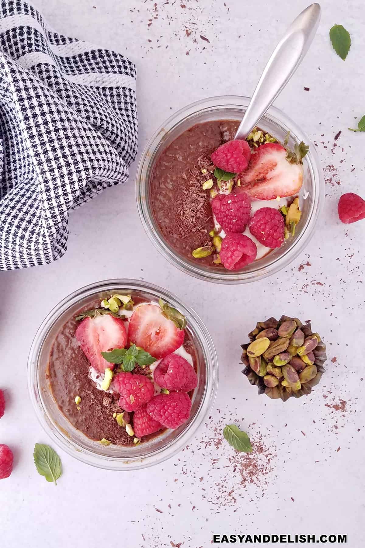 chocolate chia seed pudding in jars served with their toppings.