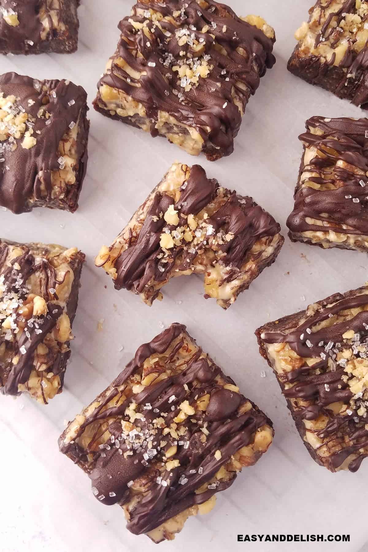 a bunch of fig bars on parchment paper. 