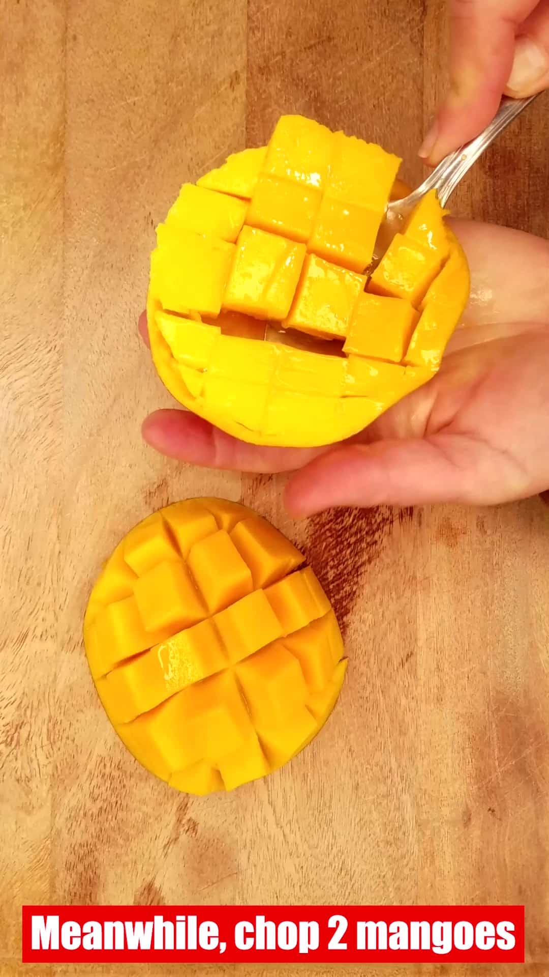 cutting mango into chunks.