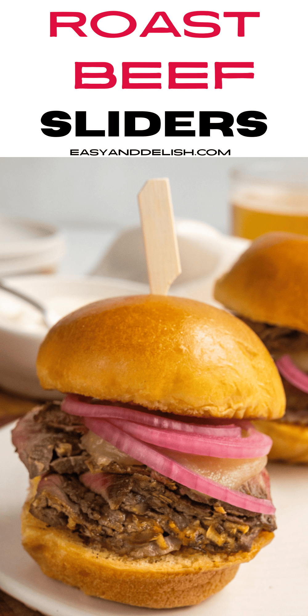 pin showing a close up of a couple of roast beef sliders. 