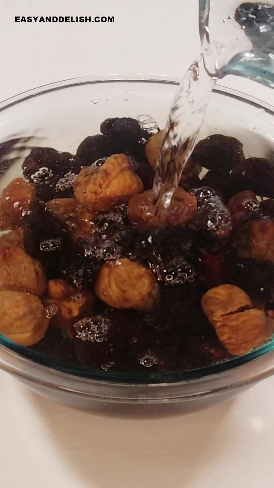 dried figs soaked in warm water in a bowl. 