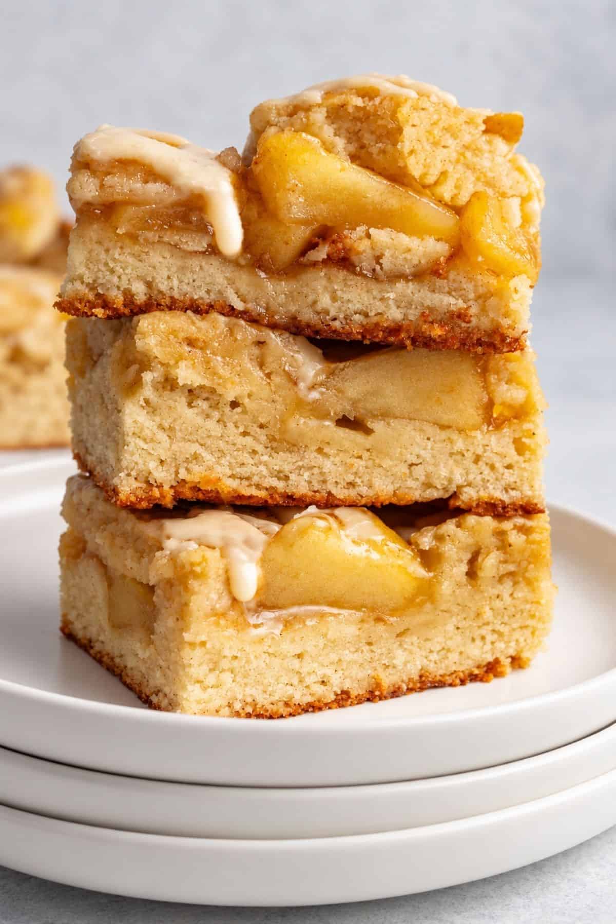 Glazed apple bars stacked with soft apple filling.