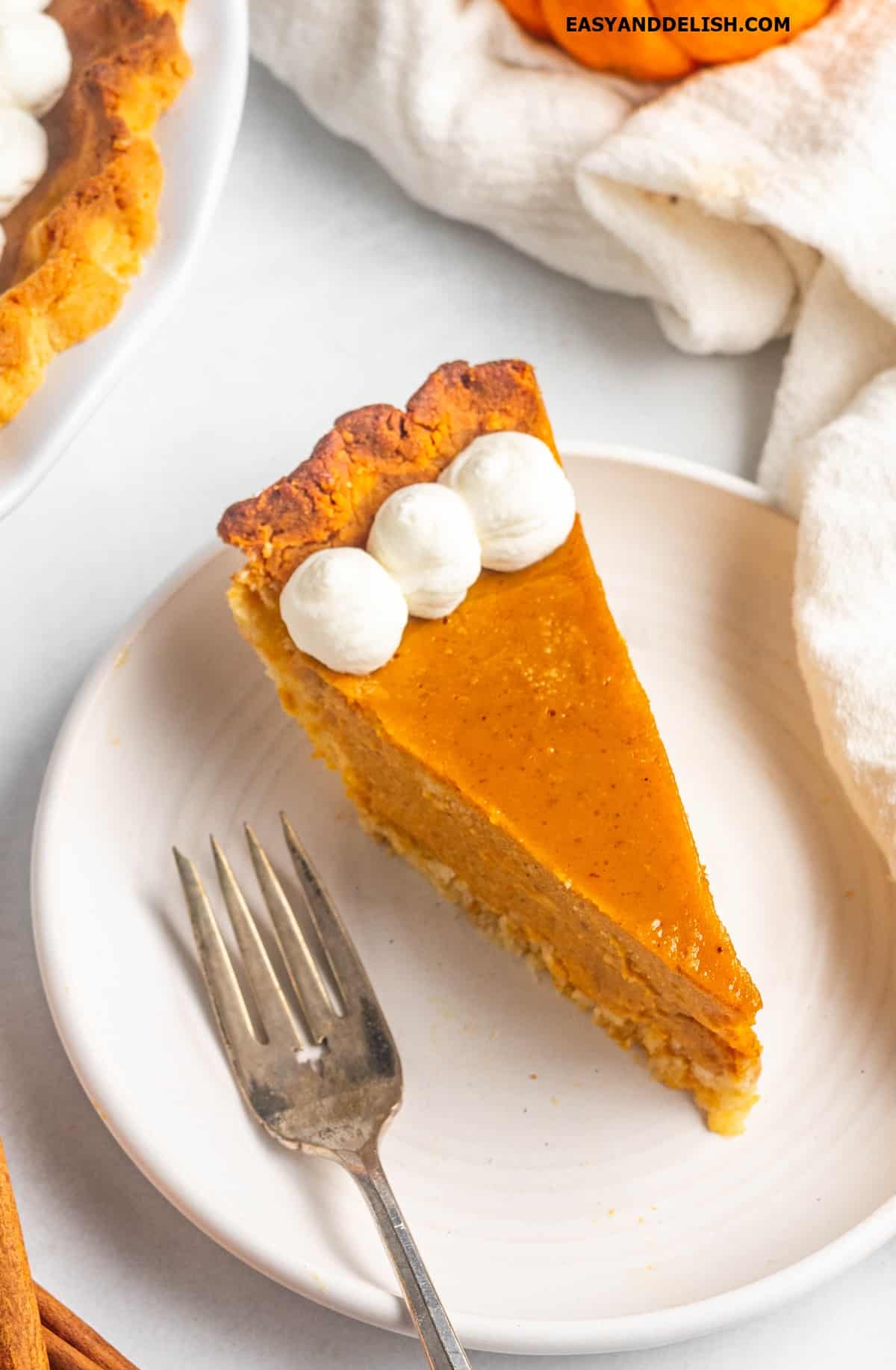 A slice of keto pumpkin pie in a plate. 