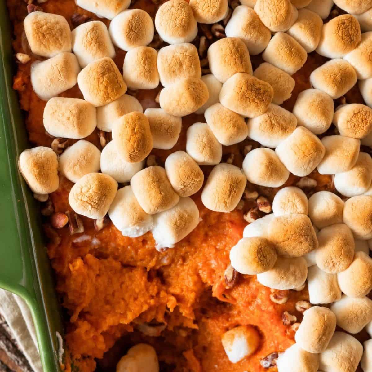 Toasted marshmallows over sweet potato filling with pecans.